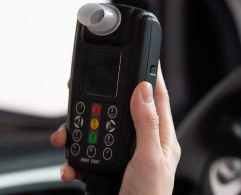 Woman holding a Smart Start Ignition Interlock Device