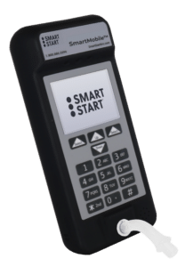 angle view of the Smart Start SmartMobile device, a portable breath alcohol testing unit with its screen on with the Smart Start logo on the screen