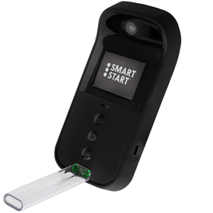 on angle view of the Smart Start Insight, a portable breath alcohol testing device with its screen on with the Smart Start logo on the screen